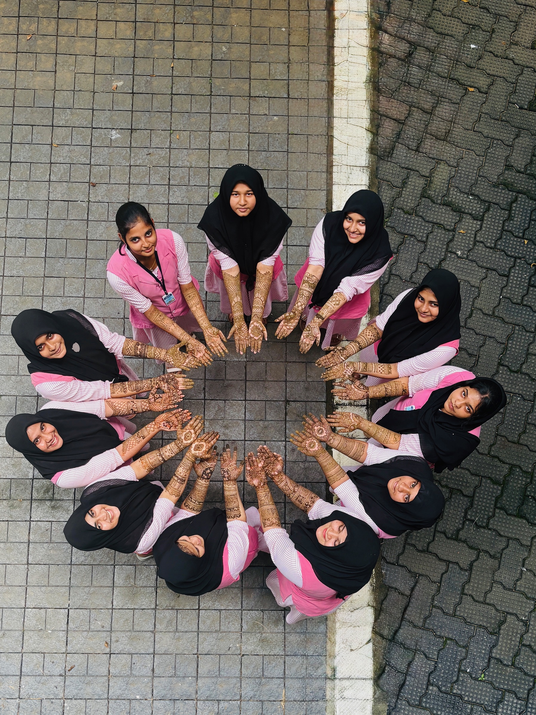 Students showing henna designs during cultural celebration